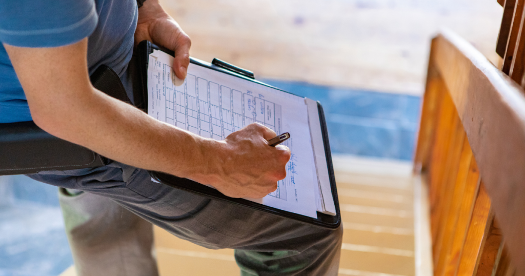 inspector taking notes on a clipboard